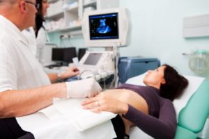 Pregnant woman receiving prenatal ultrasound scan