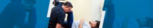 Chiropractor performing leg stretch on patient